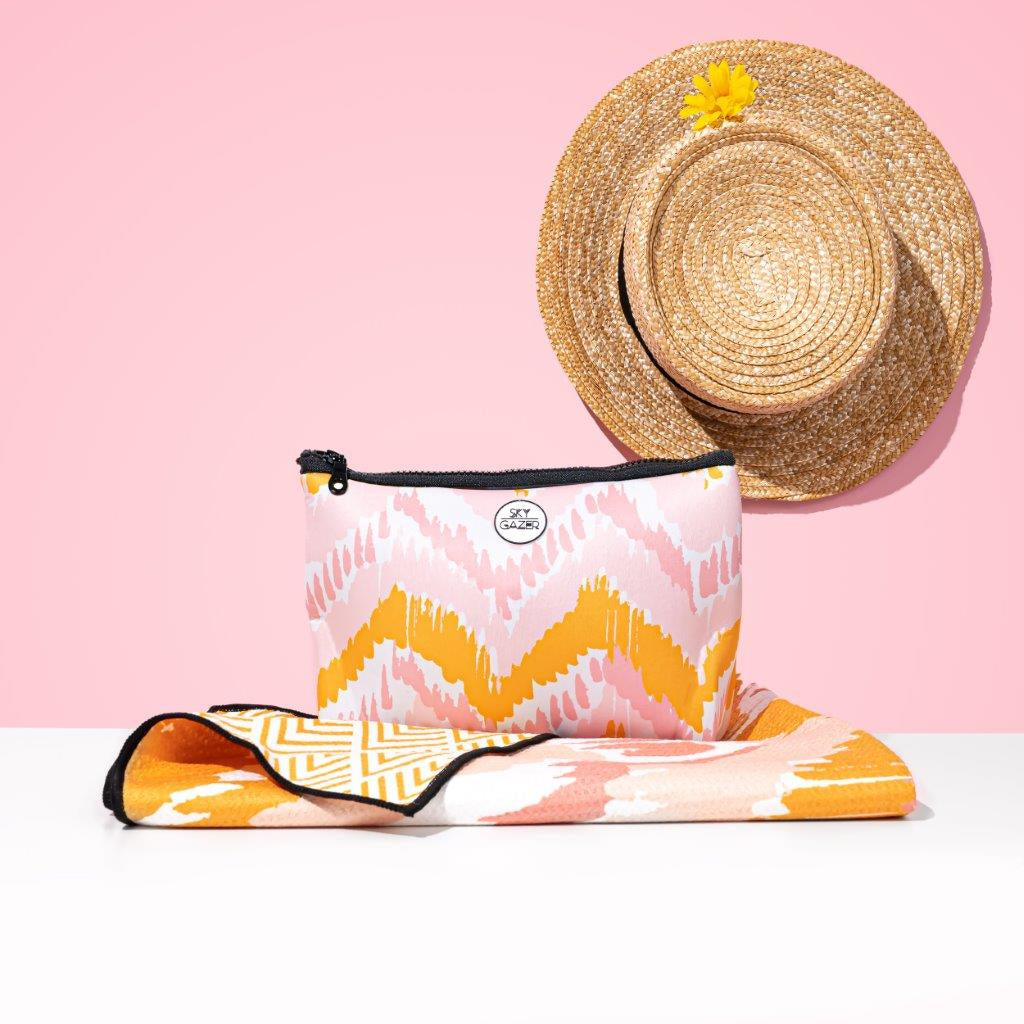 Skygazer Towel - The Airlie. A pink and orange design on towel with matching case. Available in-store and online at Eggplant+Poppy, Cairns.