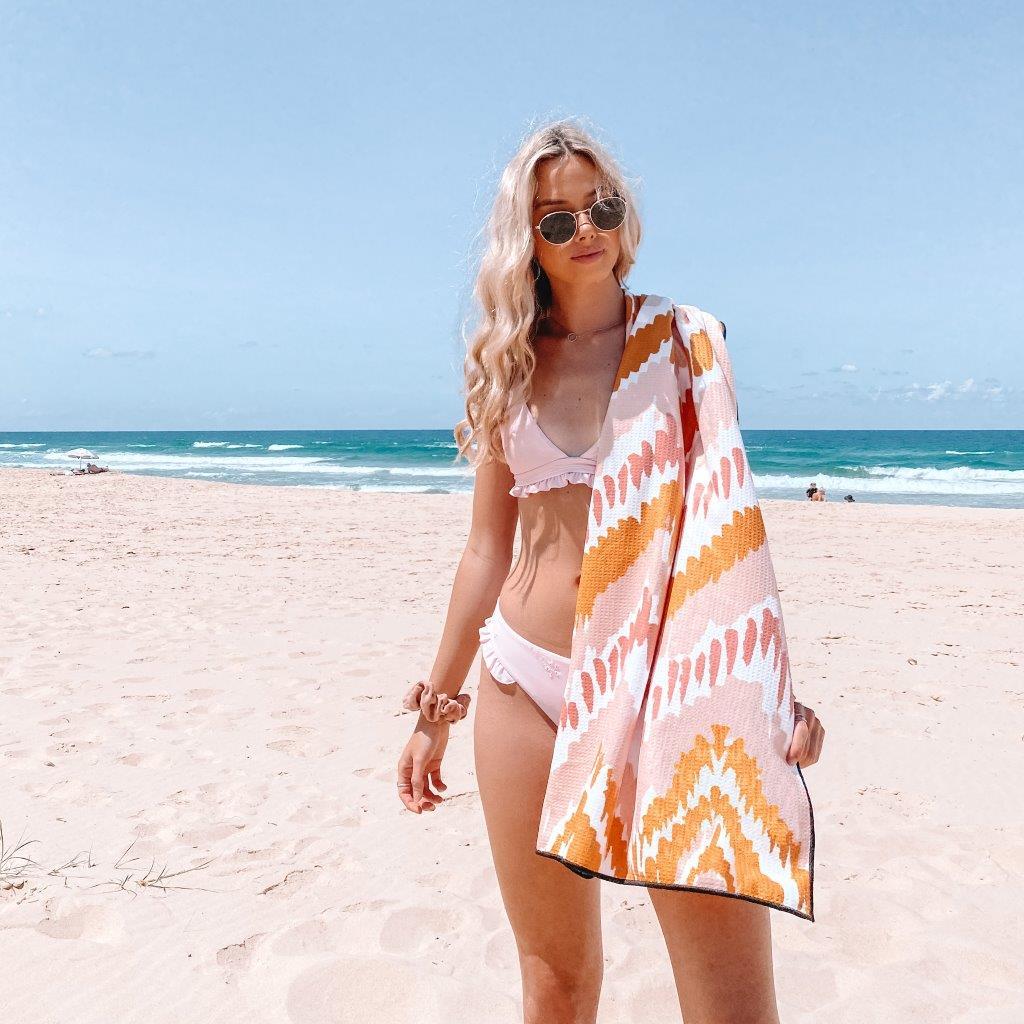 Skygazer Towel - The Airlie. A pink and orange design on towel with matching case. Available in-store and online at Eggplant+Poppy, Cairns.